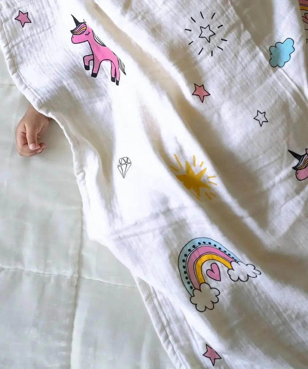White fabric with colorful unicorn and rainbow patterns on a white background