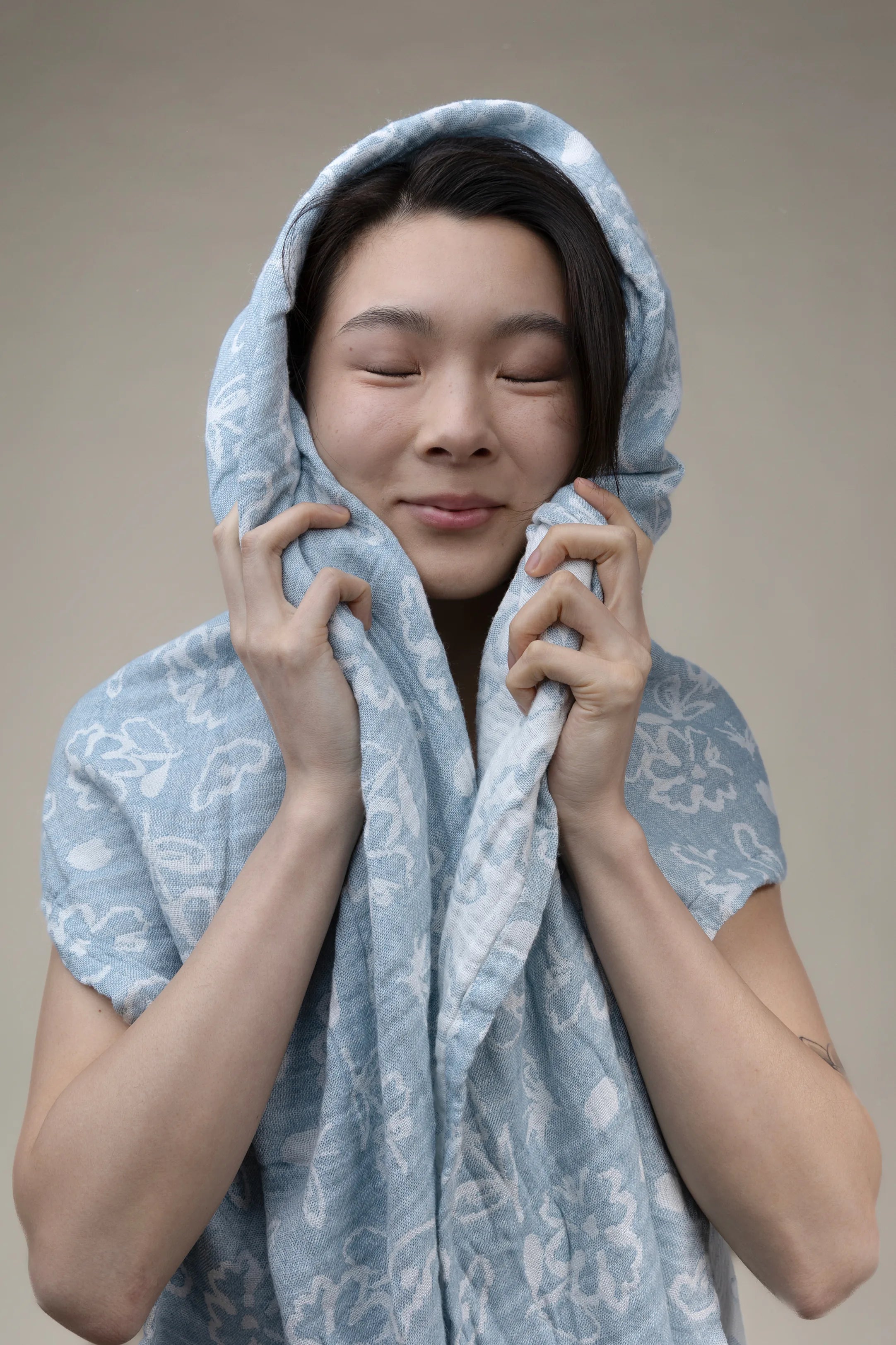 Person wrapped in a soft blue bath towel
