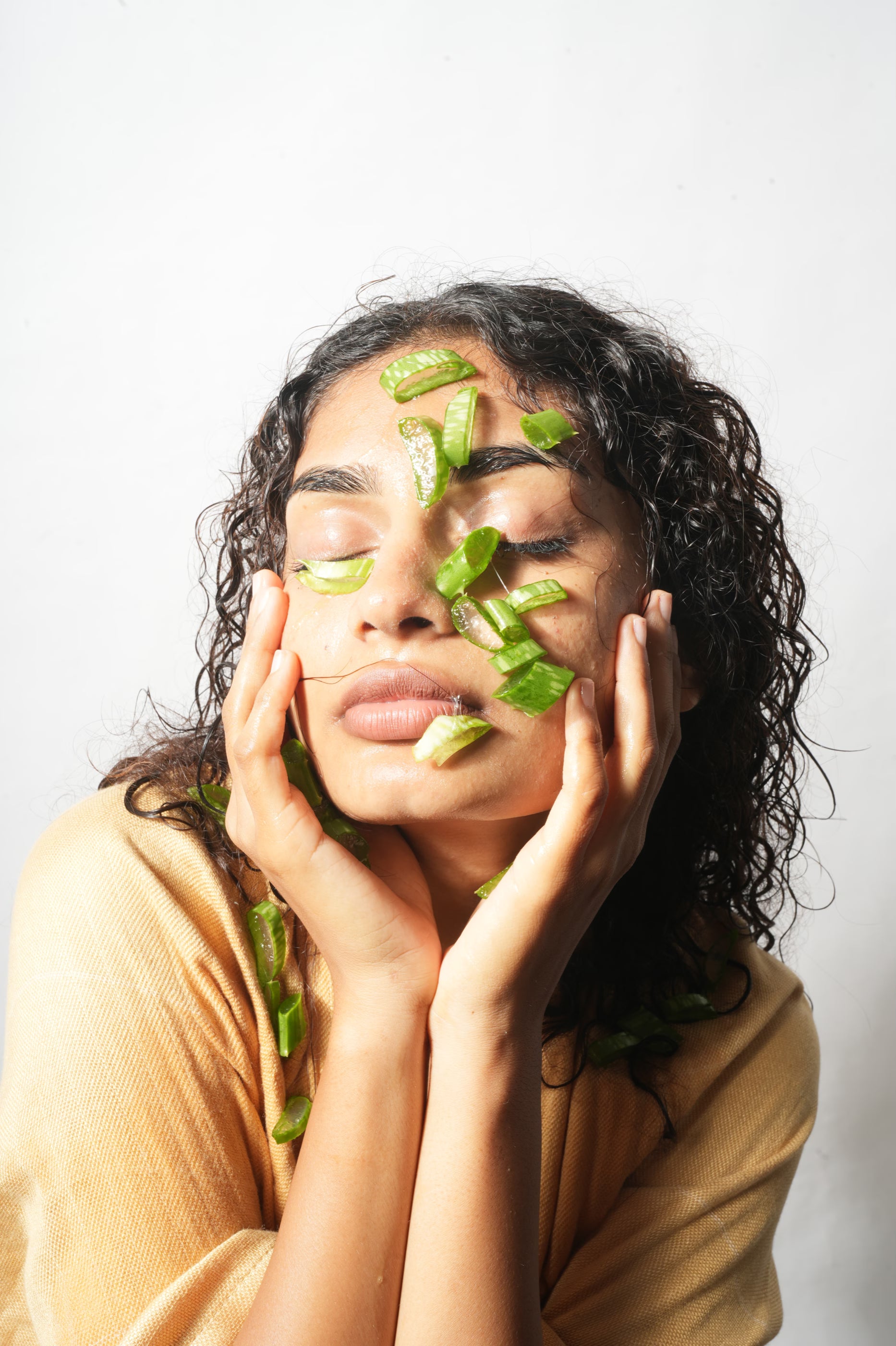 Woman caring for acne-prone skin with aloe vera
