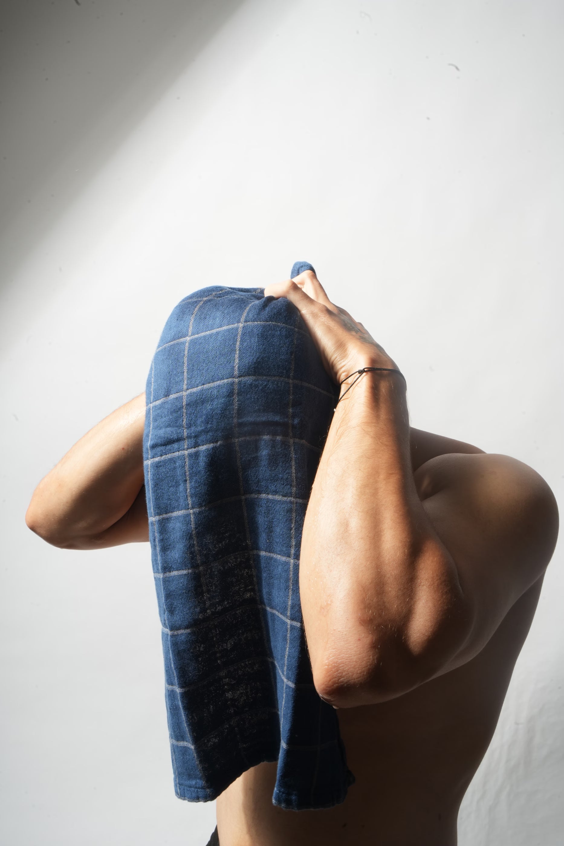 Person drying sensitive skin with a soft blue Doctor Towel